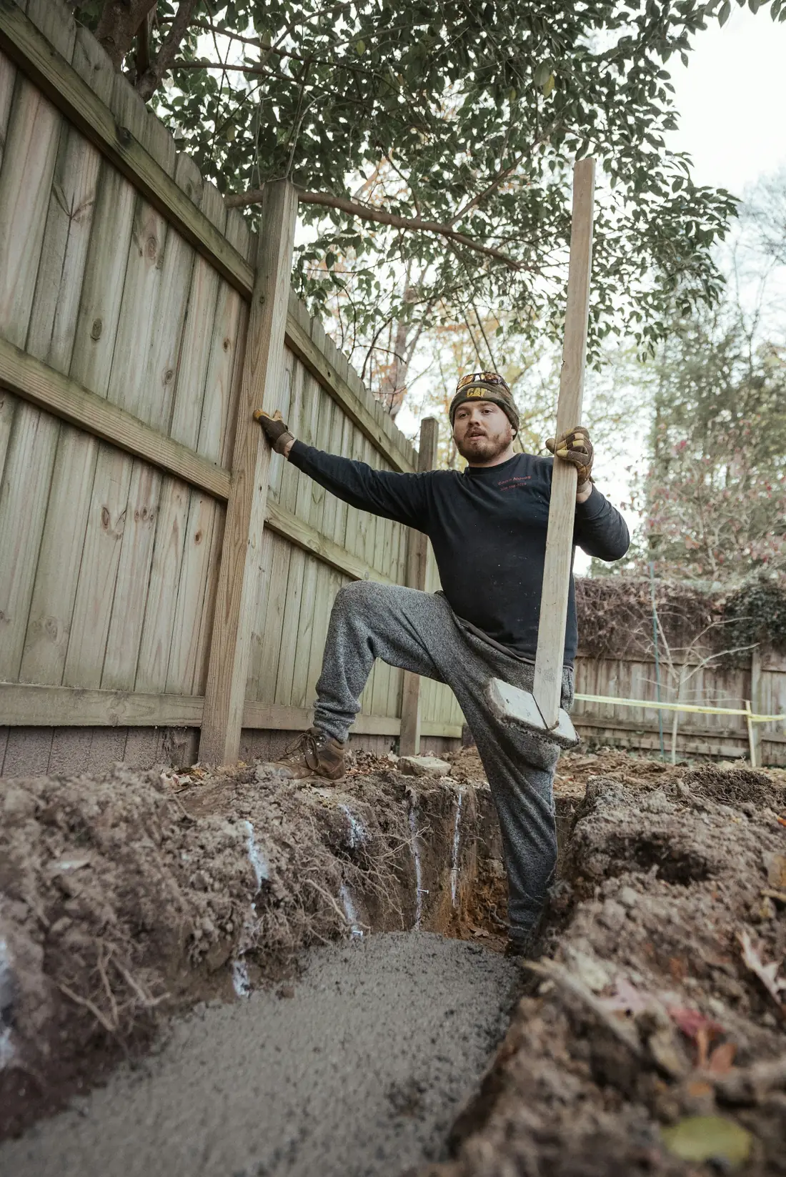 Connecticut contractor team completing a home service project with fresh concrete and fence posts in CT